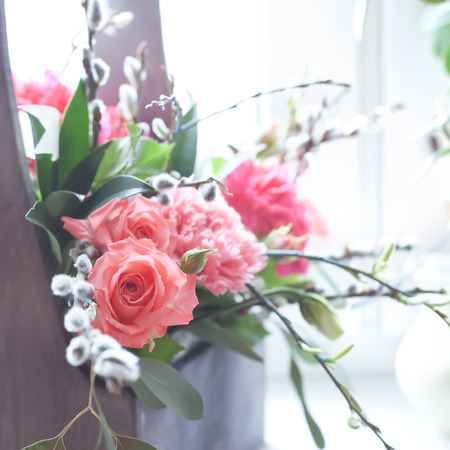 Beautiful fresh flowers in a wooden box natural light setting toned photoの写真素材