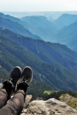 hiking boots on the peak of a mountain, hiker legsの写真素材