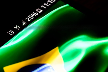 Smartphone 5G network 25 per cent charge and Brazil flagの写真素材