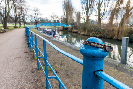 Doggie collar on railing along Nene river in Northampton UKの写真素材