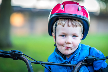 Portrait view of cyclist boy outdoors in parkの写真素材