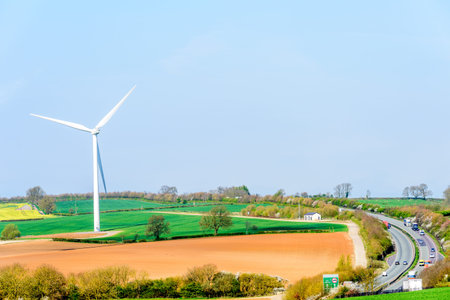 Wind Turbines and Blue Sky with Clouds over UK fields