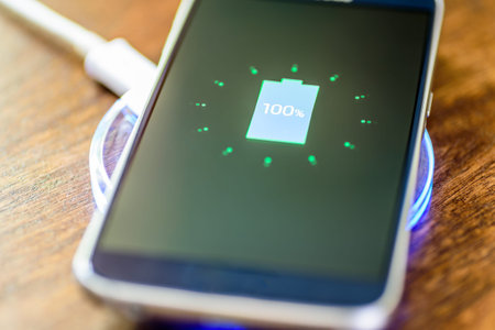 Smartphone charging on a charging pad. Wireless charging