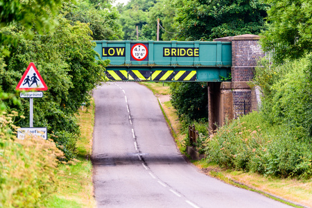 Day view of UK motorway highway under railway bridgeの写真素材