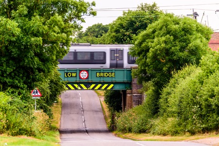Day view of UK motorway highway under railway bridgeの写真素材