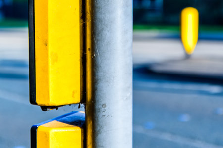 pedestrian crossing equipment in UK, with blurred pedestrians in the background