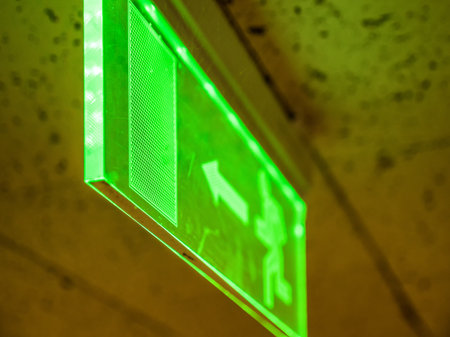 Indoor view green emergency fire exit sign on ceilingの写真素材