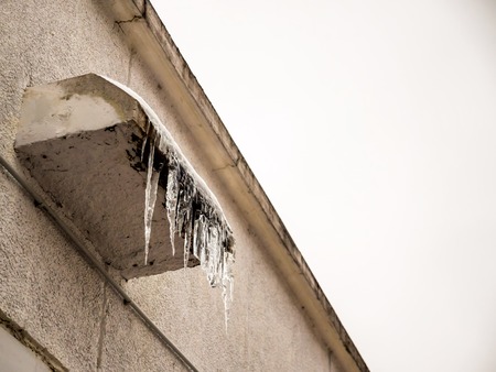 Day view lonely icicles hang on the corniceの写真素材