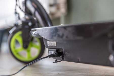 Closeup day view electric scooter charging upの写真素材