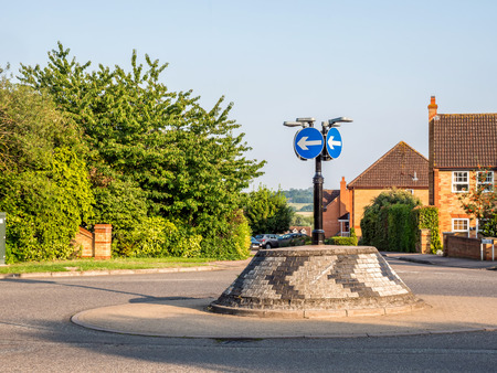 Day view of typical english brick roundabout with directional signsの写真素材