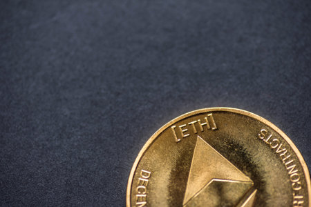 Golden virtual money Ethereum crypto currency coin on a dark background