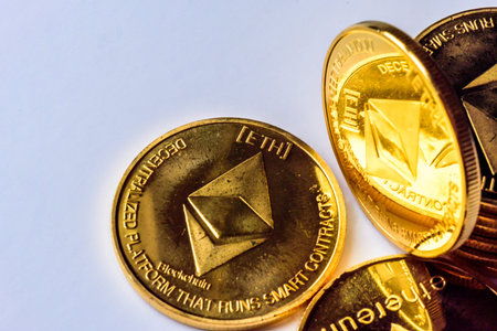 Golden virtual money Ethereum crypto currency coins stacked on a dark background
