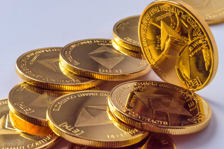 Golden virtual money Ethereum crypto currency coins stacked on a dark background