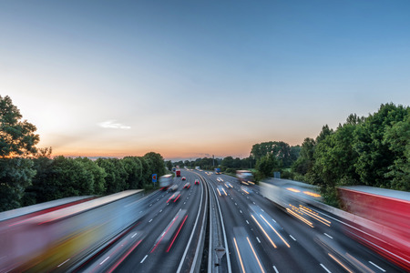 Sunset view heavy traffic moving at speed on UK motorway in Englandの写真素材