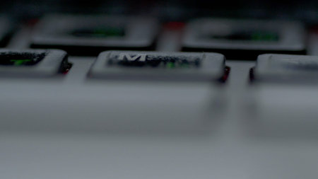 Close-up view fingers tapping keypad of laptop and writing message