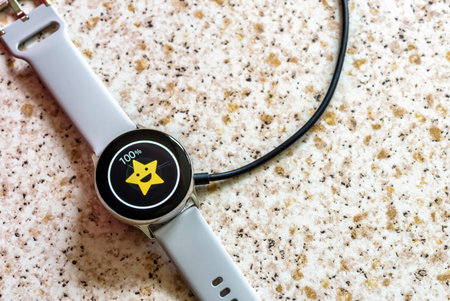 smart watch wireless charging on charging pad on kitchen worktop table