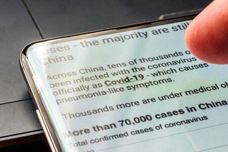coronavirus covid 19 text on smart phone screen - Northampton, UK - February 25, 2020のeditorial素材