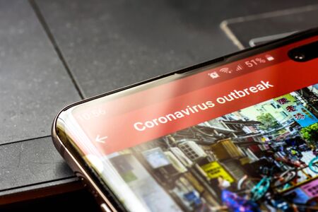 coronavirus outbrake text on smart phone screen - Northampton, UK - February 25, 2020のeditorial素材