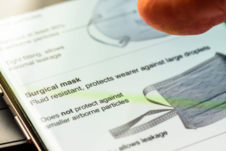 coronavirus face masks text on smart phone screen - Northampton, UK - February 25, 2020