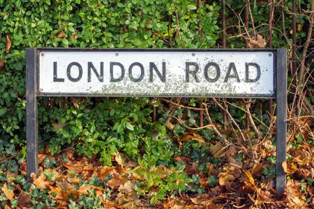 london road sign post in town in england ukの写真素材