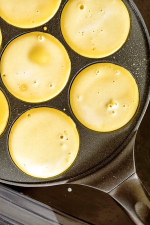 pancake frying pan with smile face pancake cooking on cooker in kitchen