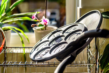 black pancake smile frying pan on plate drainer rack in kitchen