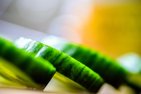 Cucumber cut slices on wooden cutting board