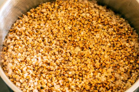 buckwheat porridge cooking in metal panの写真素材