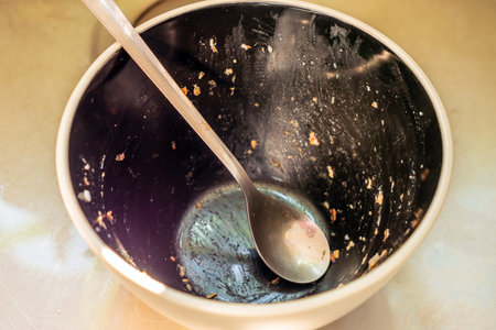 Dirty dishes stacked next to sink in home kitchen