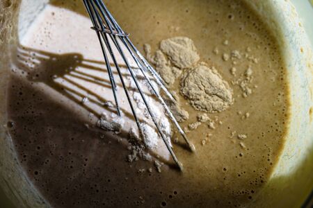 mixing wholemeal homemade vegan bread in plastic bowl.の写真素材