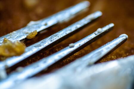 fork knife and spoon covered with apple pie icing on empty baking paper tray.の写真素材