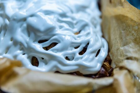 homemade fresh apple pie covered with white icing in baking tray with baking paper in itの写真素材