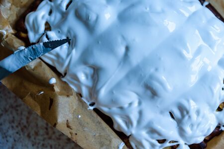 homemade fresh apple pie covered with white icing in baking tray with baking paper in itの写真素材