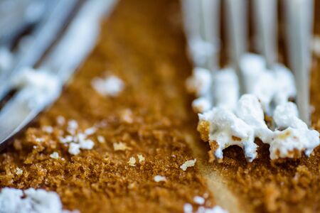 fork knife and spoon covered with apple pie icing on empty baking paper tray.の写真素材