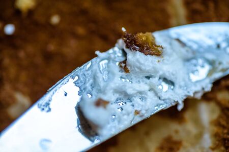fork knife and spoon covered with apple pie icing on empty baking paper trayの写真素材