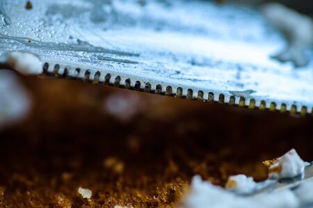 fork knife and spoon covered with apple pie icing on empty baking paper trayの写真素材