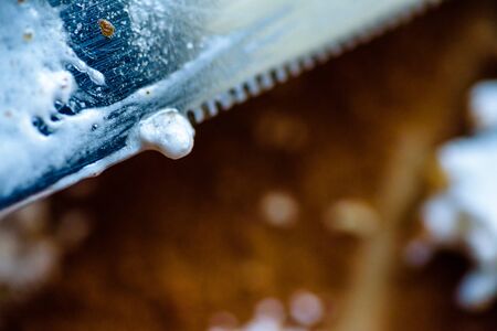 fork knife and spoon covered with apple pie icing on empty baking paper trayの写真素材