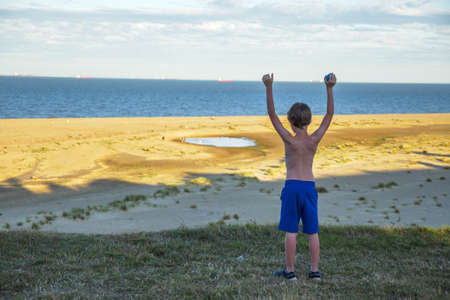 child boy over beach and sand dunes at Lowestoft Suffolkの写真素材
