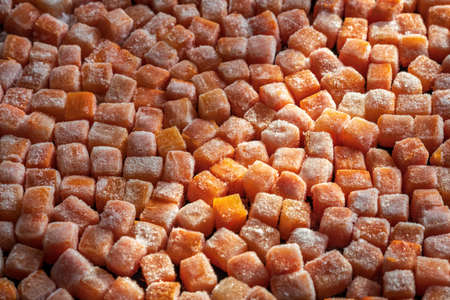 Frozen fresh carrot cube pieces closeup backgroundの写真素材