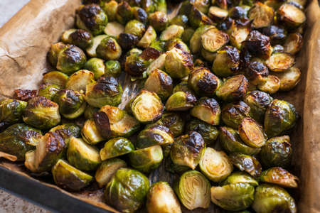 oven baked sliced brussels sprouts on baking tray closeupの写真素材