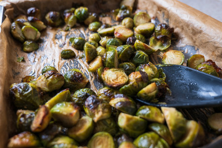 oven baked sliced brussels sprouts on baking tray closeupの写真素材