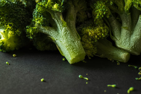 Frozen green broccoli florets on dark background closupの写真素材