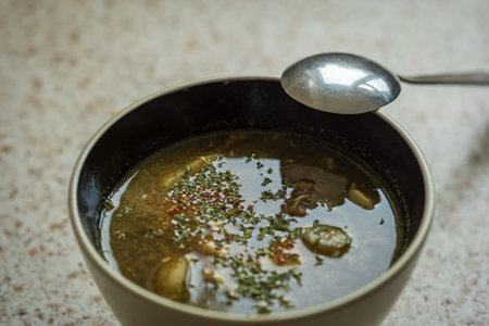 green sorrel soup in dip plate closeup