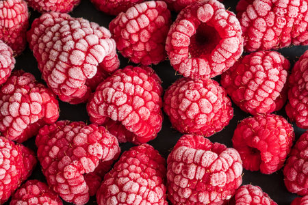 frozen red raspberries background closeup