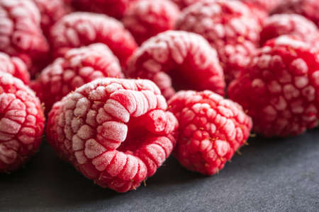 frozen red raspberries background closeupの写真素材