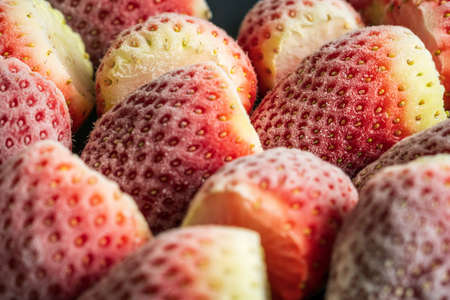 frozen ripe strawberries background closeupの写真素材