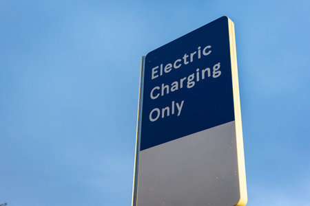 Electric vehicle recharging point sign post in England UKの写真素材