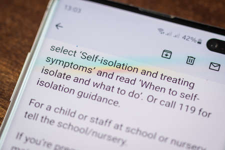Covid 19 email notification on smartphone screen in england UKの写真素材
