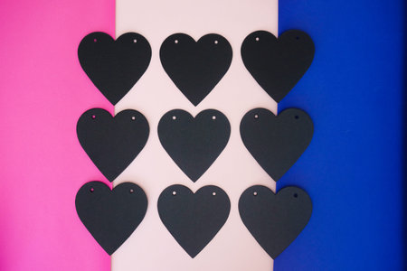 Postcard in shape of heart on Valentines day. Black heart on pink background.
