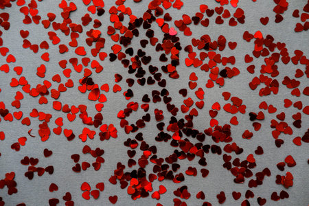 Red heart confetti on February 14 for Valentine's Day.
